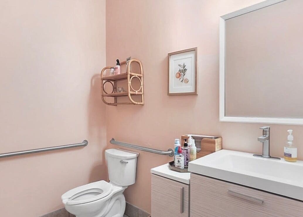 Elegant restroom at LOR Beauty Concept, Jacksonville, Florida, US with modern design and soft pink walls.