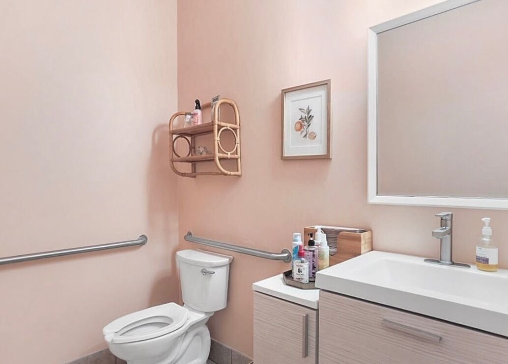 Elegant restroom at LOR Beauty Concept, Jacksonville, Florida, US with modern design and soft pink walls.