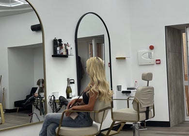 Maya The Hairstylist salon in Redditch, England, GB, showcasing modern styling chairs and sleek large mirrors.