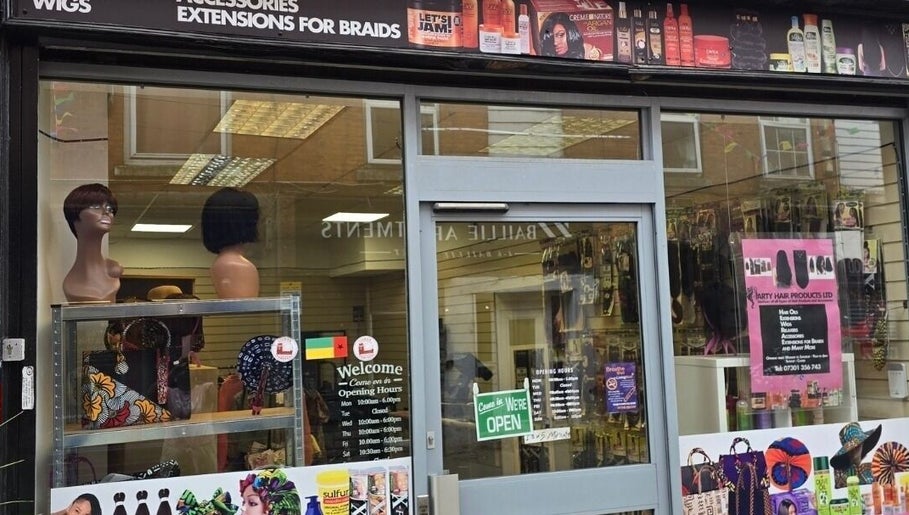 Exterior view of Arty beauty store in Rochdale, England, showcasing wigs and accessories in window.