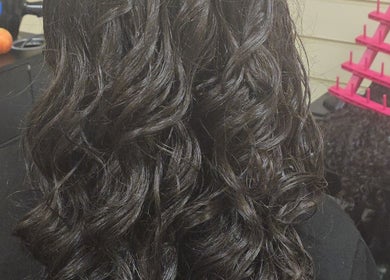 Lustrous curly hair styled at Arty salon, Rochdale, England, GB.