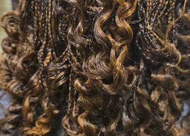 Intricate curly braids at Arty in Rochdale, England, GB, showcasing detailed hair artistry.