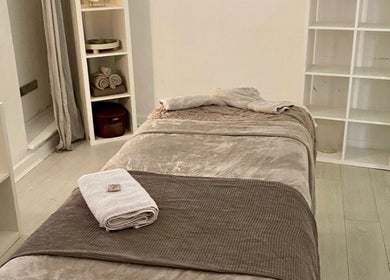 Relaxing massage room at Rae’s Retreat Massage, St Helens, England, GB, featuring a comfy table and soft lighting.