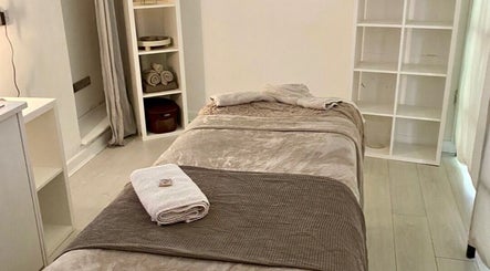 Relaxing massage room at Rae’s Retreat Massage, St Helens, England, GB, featuring a comfy table and soft lighting.