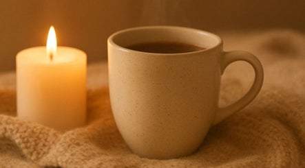 Warm tea and candlelight at Golden Light Reiki, Tickenham, Bristol, England, GB create a soothing ambiance.