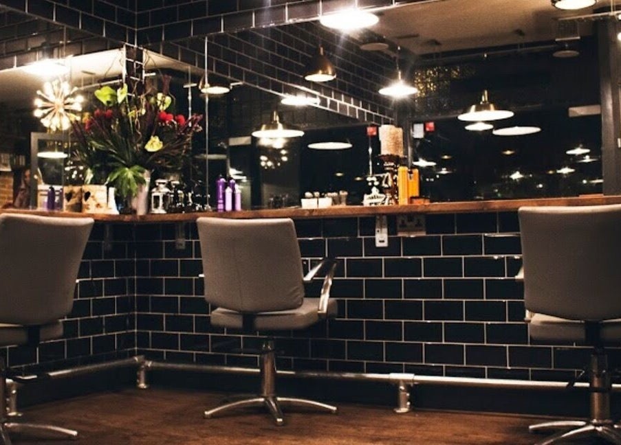 Modern hair salon at Jade @ Chandler & Hall, Southbourne, England, GB, with sleek chairs and stylish decor.