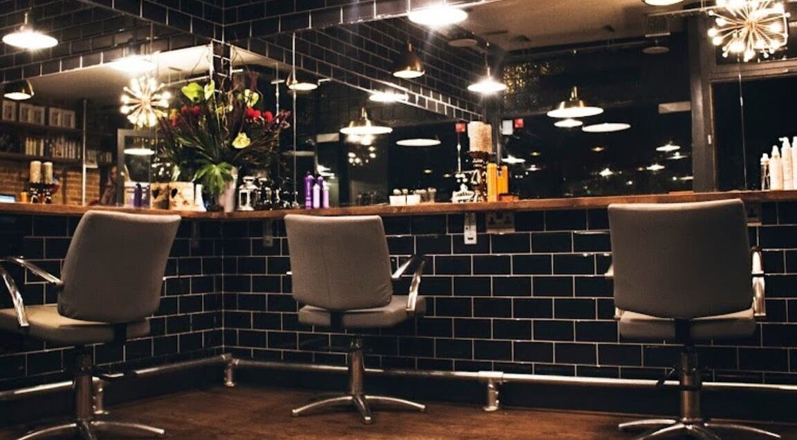 Modern hair salon at Jade @ Chandler & Hall, Southbourne, England, GB, with sleek chairs and stylish decor.