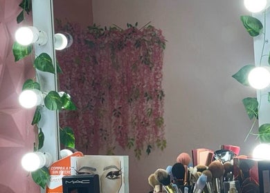 Espejo iluminado en Diana Sánchez Studio, Ciudad De México, MX. Decorado con hojas y maquillaje profesional.