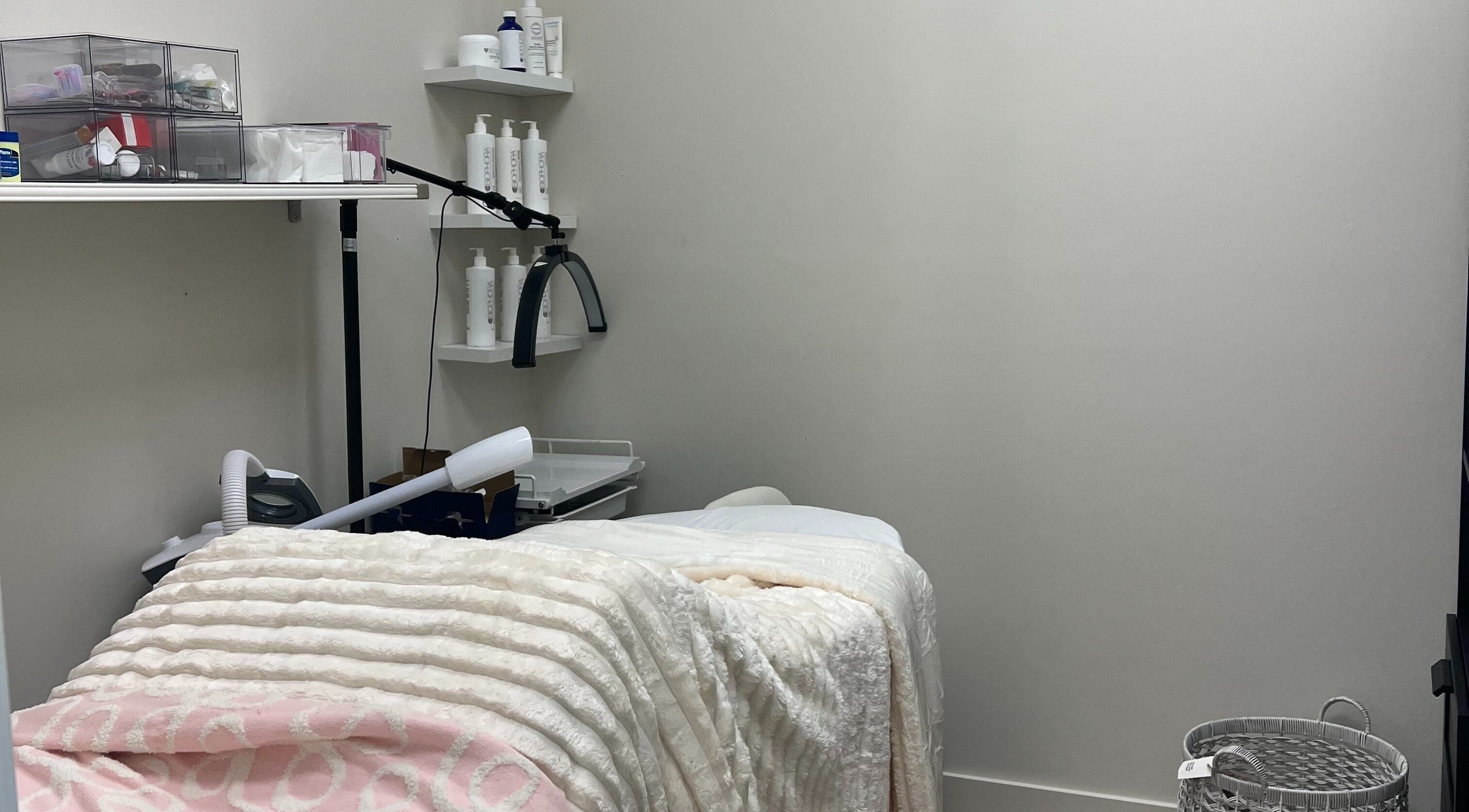 Relaxing treatment room at Glow Essence Beauty in Vaughan, Ontario, CA equipped for skincare therapies.