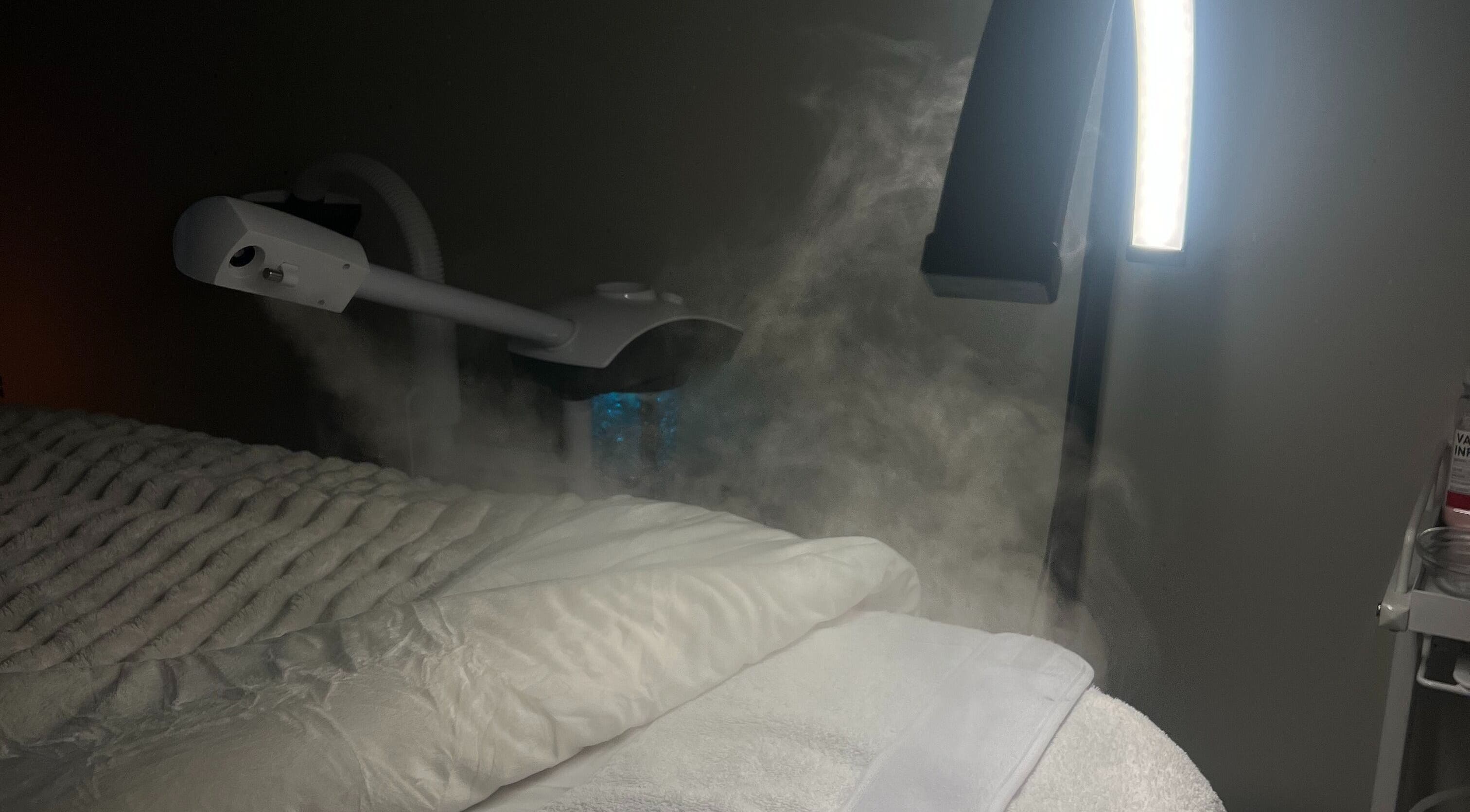 Luxurious spa bed with facial steamer at Glow Essence Beauty in Vaughan, Ontario, CA.