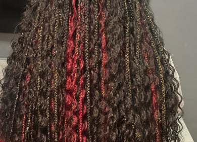 Intricate braided hairstyle at Naomiscrownedtouch, London, England, GB, showcasing red and gold accents.
