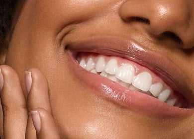 Close-up of a smiling person at Avn Aesthetics, Oshawa, Ontario, CA showcasing bright, healthy teeth.