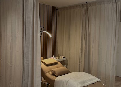 Relaxing treatment room at Queen B Beauty, Newhaven, England, GB, with a cozy massage bed and soft lighting.