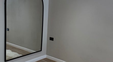 Sleek wall mirror at Queen B Beauty, Newhaven, England, GB, enhancing modern decor.