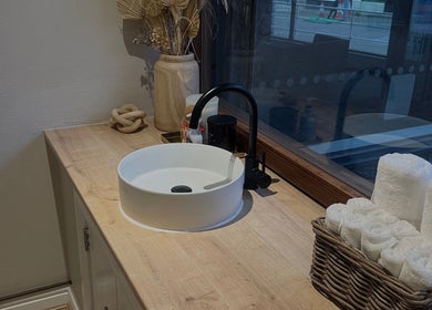 Elegant sink setup at Queen B Beauty, Newhaven, England. Features rolled towels and decor for a relaxing atmosphere.