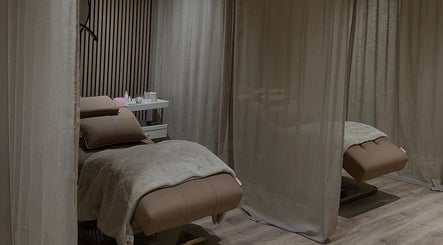 Luxurious massage room at Queen B Beauty, Newhaven, England, GB, featuring elegant decor.
