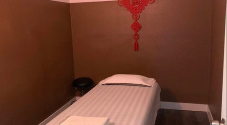 Cozy massage room at Healthy Life Spa & Massage, Las Vegas, Nevada, US with warm decor and a comfortable bed.