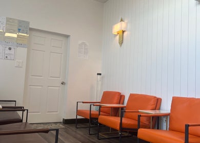 Relaxing seating area at Healthy Life Spa & Massage in Las Vegas, Nevada, US with orange chairs.