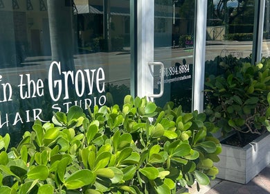 Entrance of Bristol Haircare at In the Grove Hair Studio, Delray Beach, Florida, US, adorned with lush greenery.