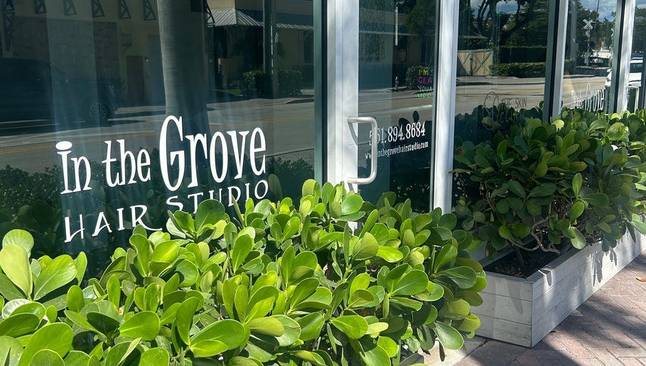 Entrance of Bristol Haircare at In the Grove Hair Studio in Delray Beach, Florida, US with lush greenery.