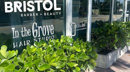 Entrance of Bristol Haircare at In the Grove Hair Studio in Delray Beach, Florida, US with lush greenery.
