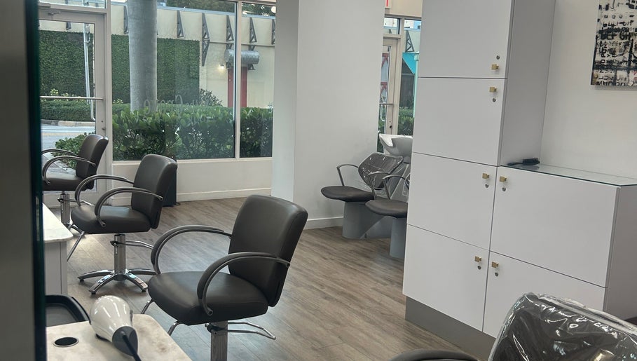 Modern salon interior at Bristol Haircare, Delray Beach, Florida, US showcasing styling chairs and wash stations.