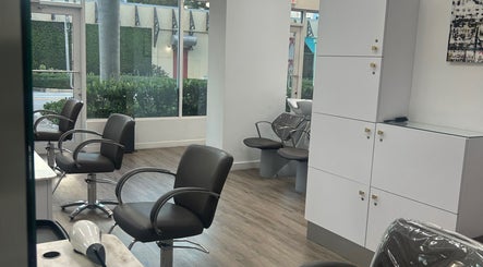 Modern salon interior at Bristol Haircare, Delray Beach, Florida, US showcasing styling chairs and wash stations.