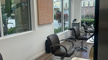Modern salon chairs at Bristol Haircare, Delray Beach, Florida, US, with vibrant artwork and street view.
