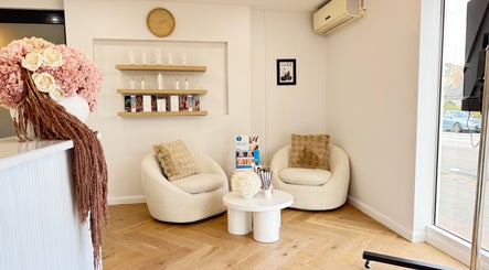 Inviting seating area at illuminate Laser Emporium, Melbourne, Victoria, AU, featuring modern decor.