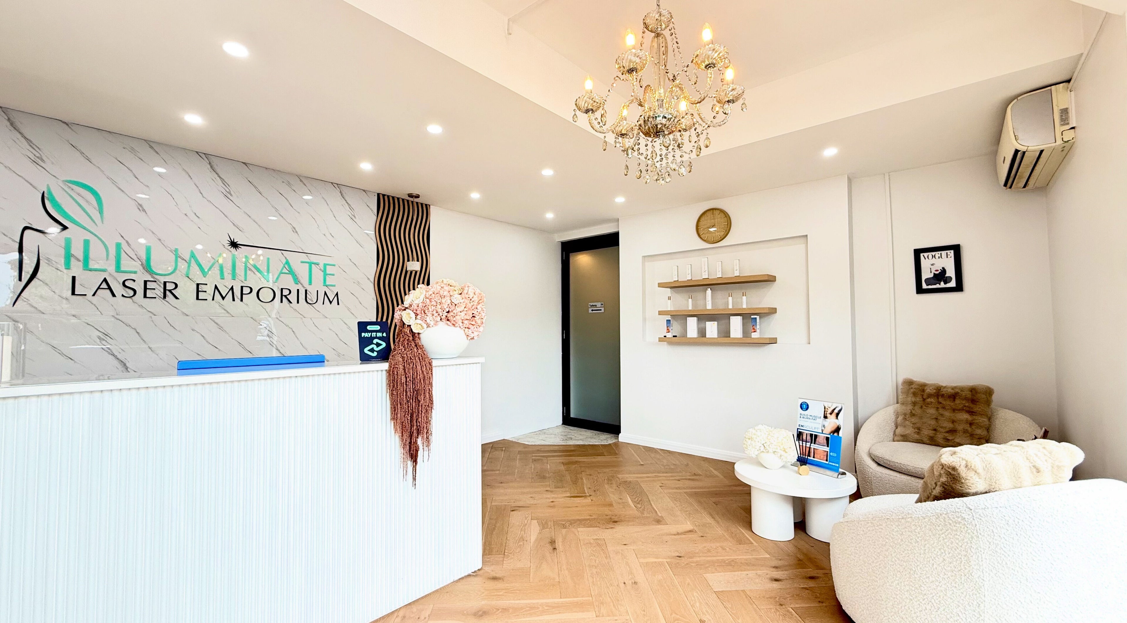 Elegant reception area at illuminate Laser Emporium, Melbourne, Victoria, AU with chandelier and cozy seating.