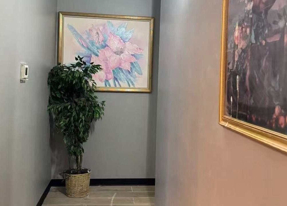 Calming hallway with art and plant at Healing Lotus Head Spa Massage, Virginia Beach, Virginia, US.