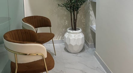 Stylish waiting area with modern chairs and plant at Blowbar Ladies Saloon, Dubai, Dubai, AE.
