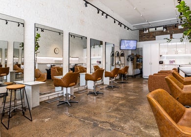 Modern interior of Bespoke Hair salon in Fortitude Valley, Queensland, AU, highlighting mirrors and seating areas.