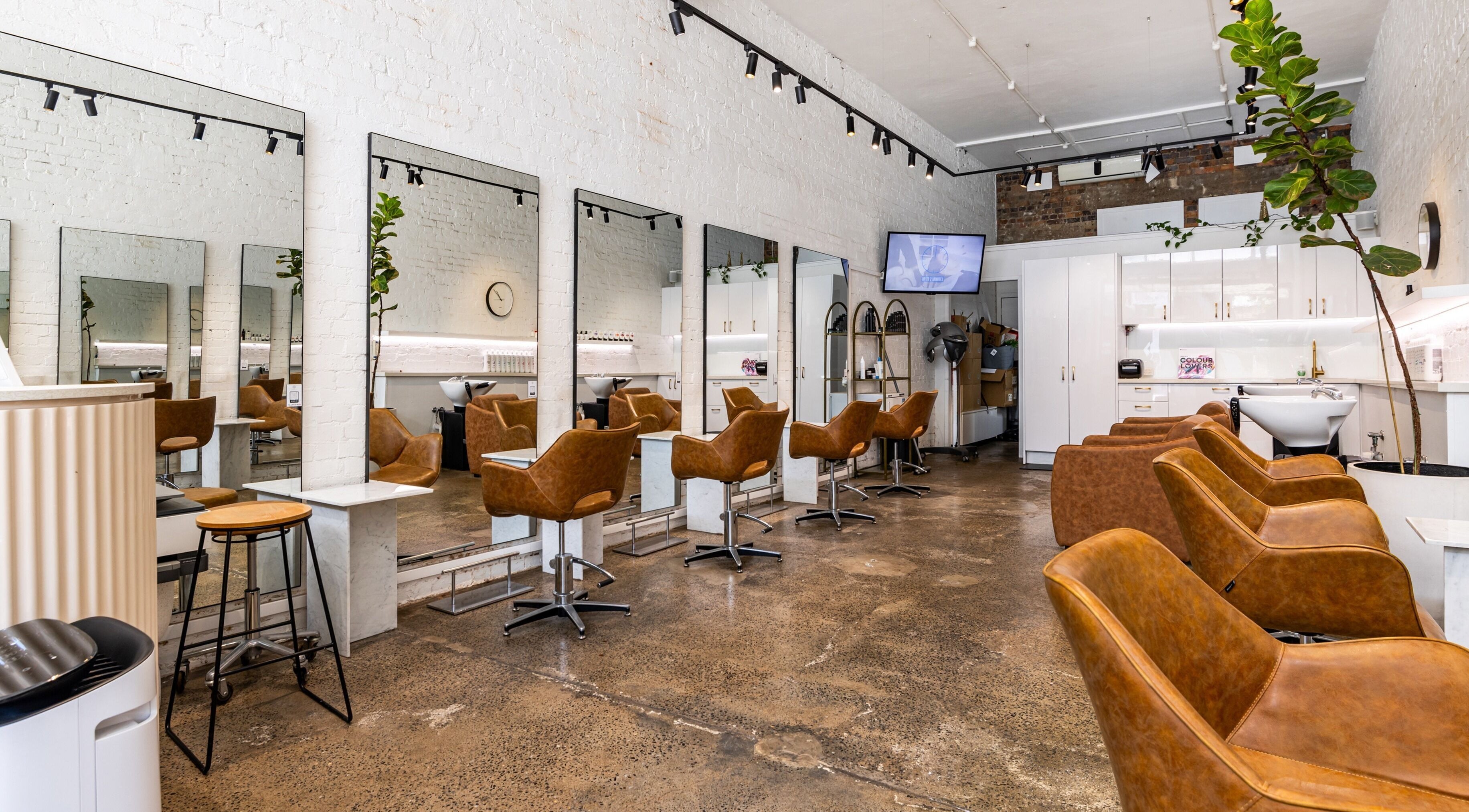 Modern interior of Bespoke Hair salon in Fortitude Valley, Queensland, AU, highlighting mirrors and seating areas.