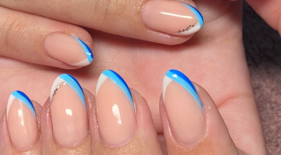 Blue and white nail art at Bloom & Thrive Beauty, Parys, Free State, ZA salon showcasing elegant design.
