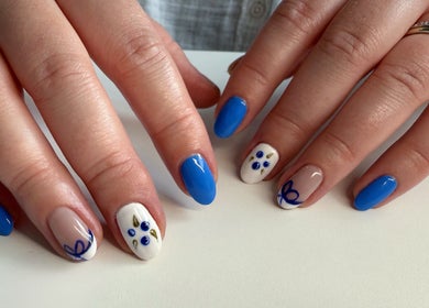 Stylish blue and white nail art at Esthetics by Sydney in South Glengarry, Ontario, CA.