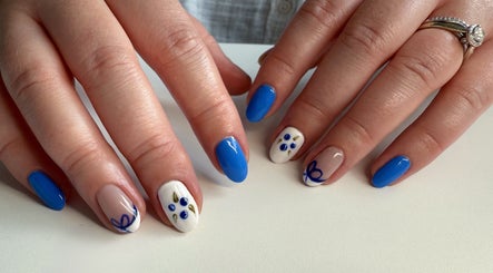 Stylish blue and white nail art at Esthetics by Sydney in South Glengarry, Ontario, CA.