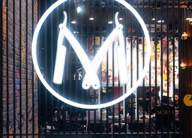 Neon barber logo at Moe & Co West Gosford, New South Wales, AU with vibrant interior decor.