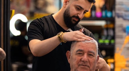 Professional barber at Moe & Co West Gosford grooming a client's hair in West Gosford, New South Wales, AU.