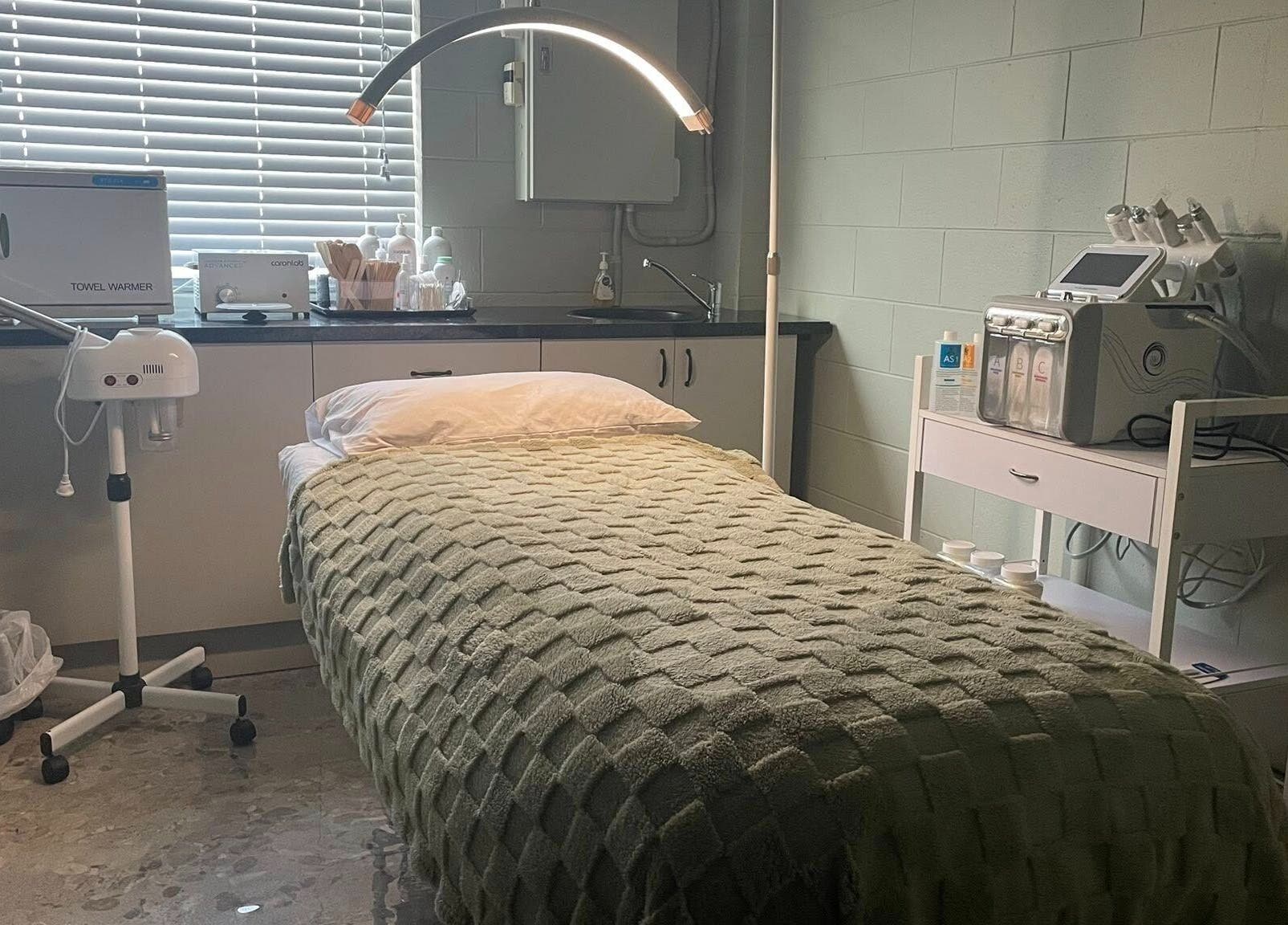 Relaxing treatment room at Viktor - Men's Grooming Lounge, Caloundra, Queensland, AU, featuring a cozy bed.