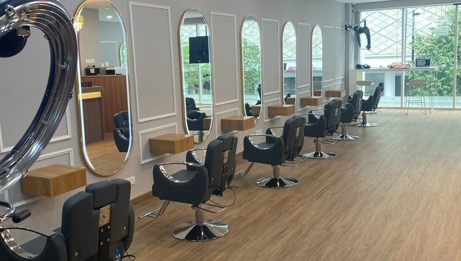 Modern hair salon interior at SEOUL SALON in Kuala Lumpur, featuring stylish chairs and mirrors.