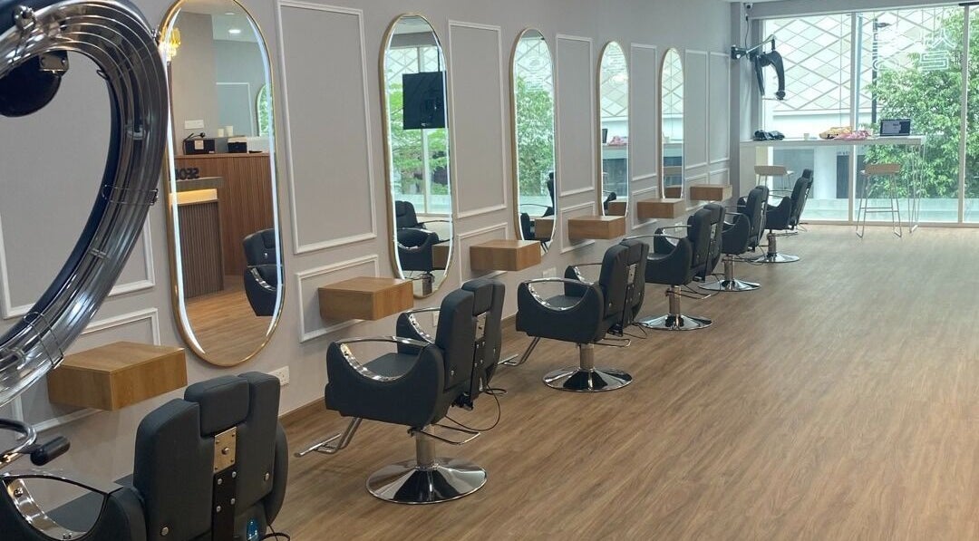 Modern hair salon interior at SEOUL SALON in Kuala Lumpur, featuring stylish chairs and mirrors.