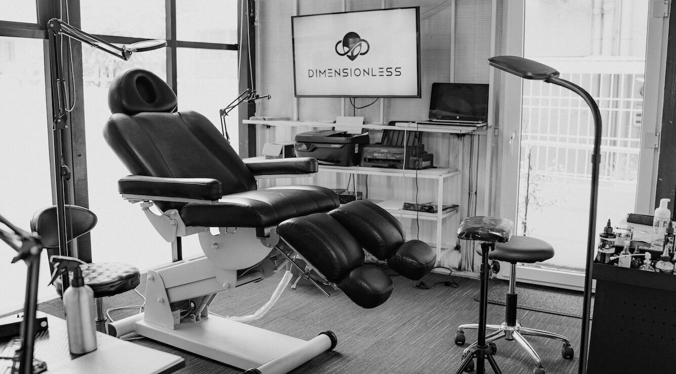 Interior of Dimensionless Tattoo Studio in Bengaluru, Karnataka, IN, featuring modern tattoo chair and equipment.