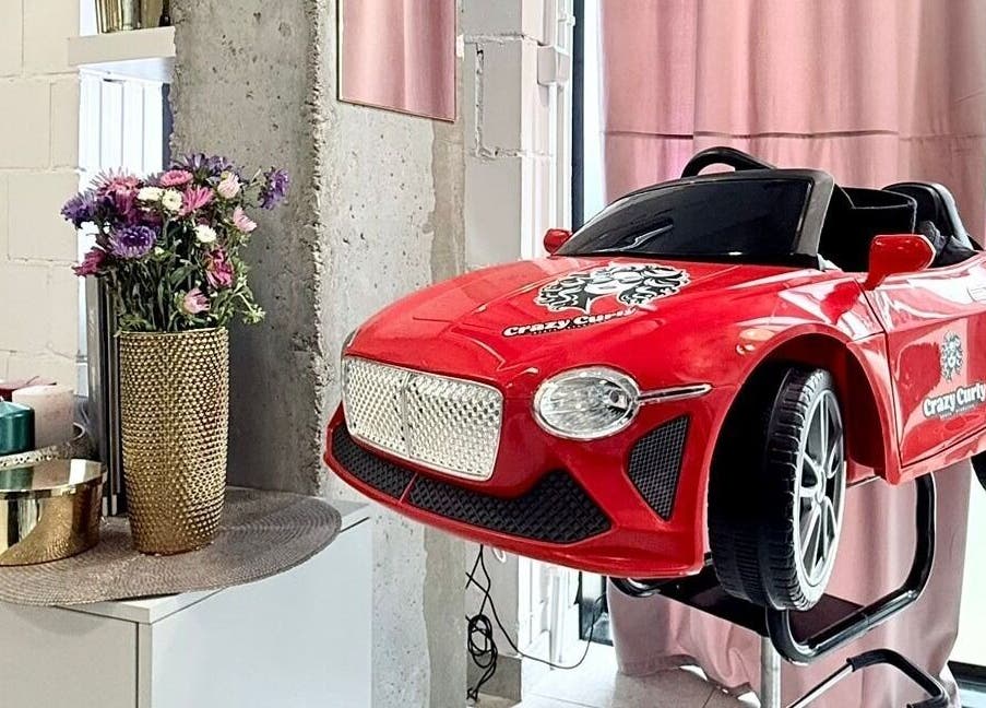 Fotel dziecięcy w formie czerwonego auta w Crazy Curly Fryzjer Wilanów - Beata Stańczak, Warszawa, Województwo Mazowieckie, PL.