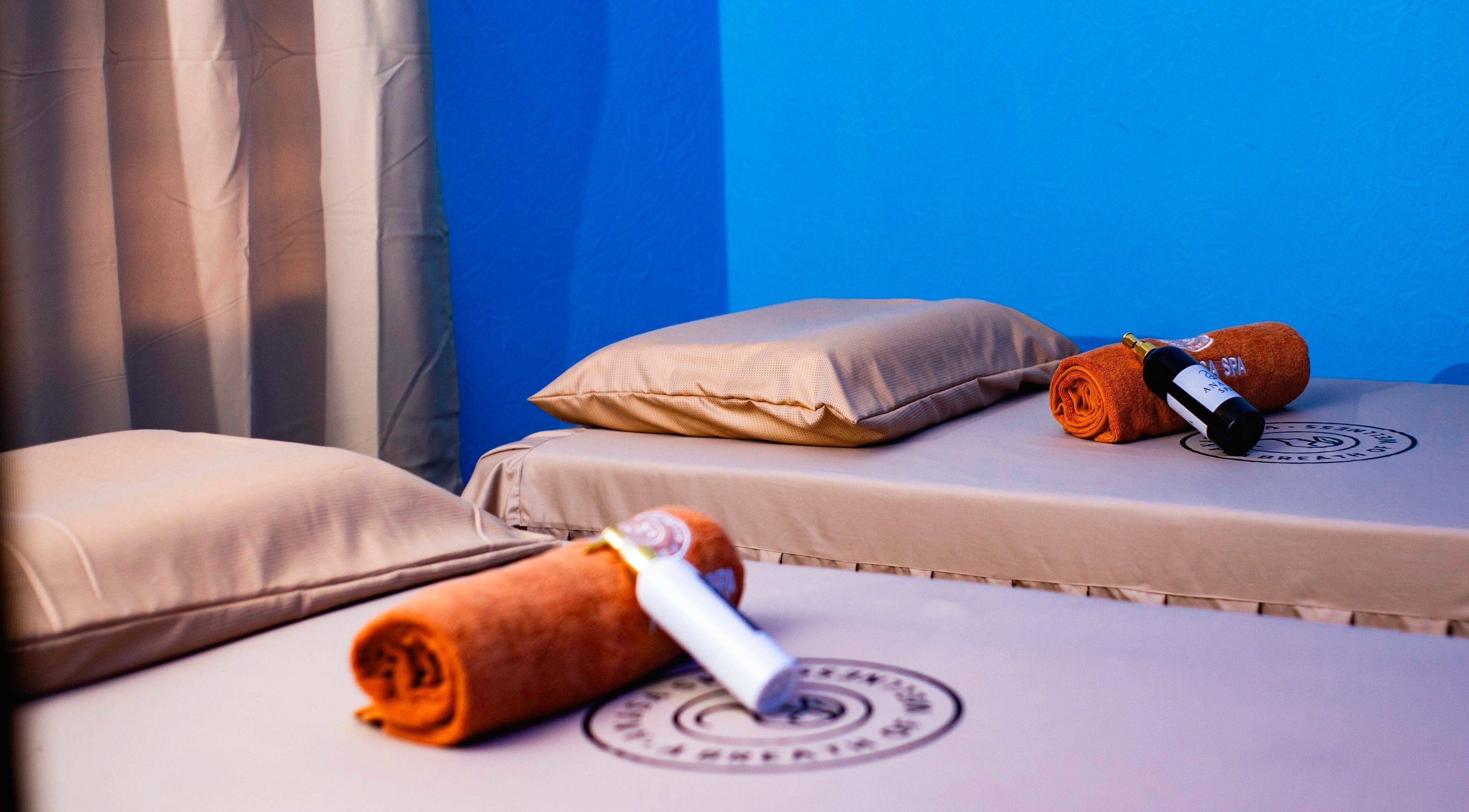 Serene spa room at Anasa Spa & Wellness in Ogbodjo, Greater Accra featuring two massage beds with essentials.