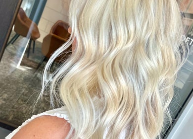 Blonde, wavy hairstyle at SDZ Hair Loft in Dublin, Ohio, US. Perfectly styled for a chic look.
