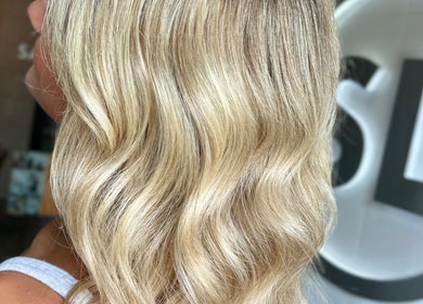 Close-up of wavy blonde hair at SDZ Hair Loft, Dublin, Ohio, US. Elegant styling and shine.