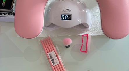 Balkan Glam Nails in London, England, GB features a UV LED lamp and pink nail tools for manicures.