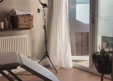 Relaxing treatment room at Recentre Aesthetics, Stockport, England, GB with cozy decor and natural light.