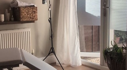 Relaxing treatment room at Recentre Aesthetics, Stockport, England, GB with cozy decor and natural light.